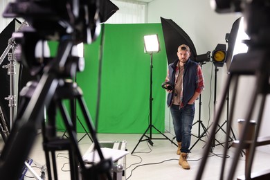 Man working with professional equipment in modern film studio