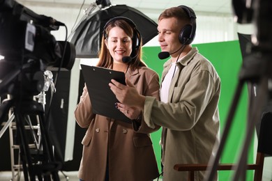 Photo of Man and woman working in modern film studio