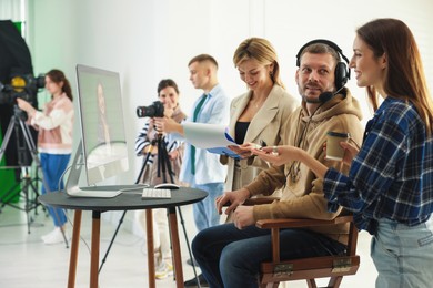 Group of people working in modern film studio