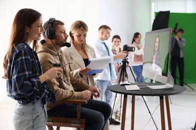 Group of people working in modern film studio