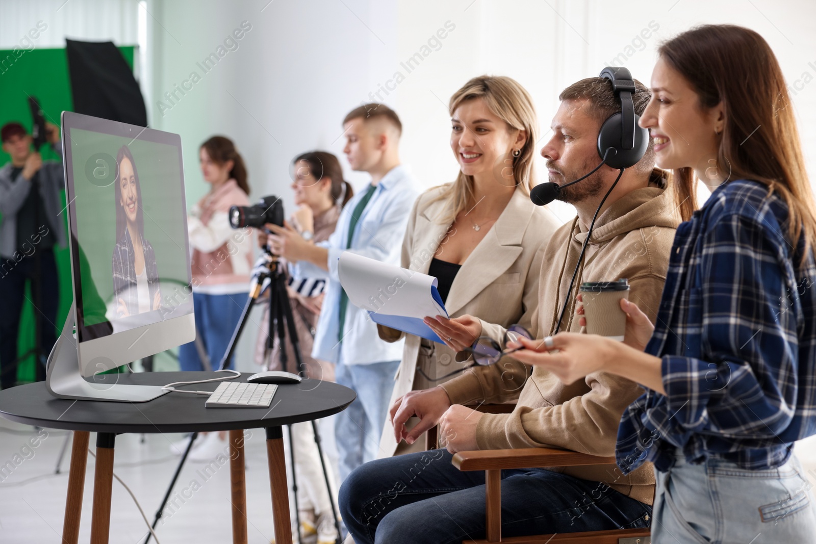 Photo of Group of people working in modern film studio