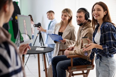 Group of people working in modern film studio