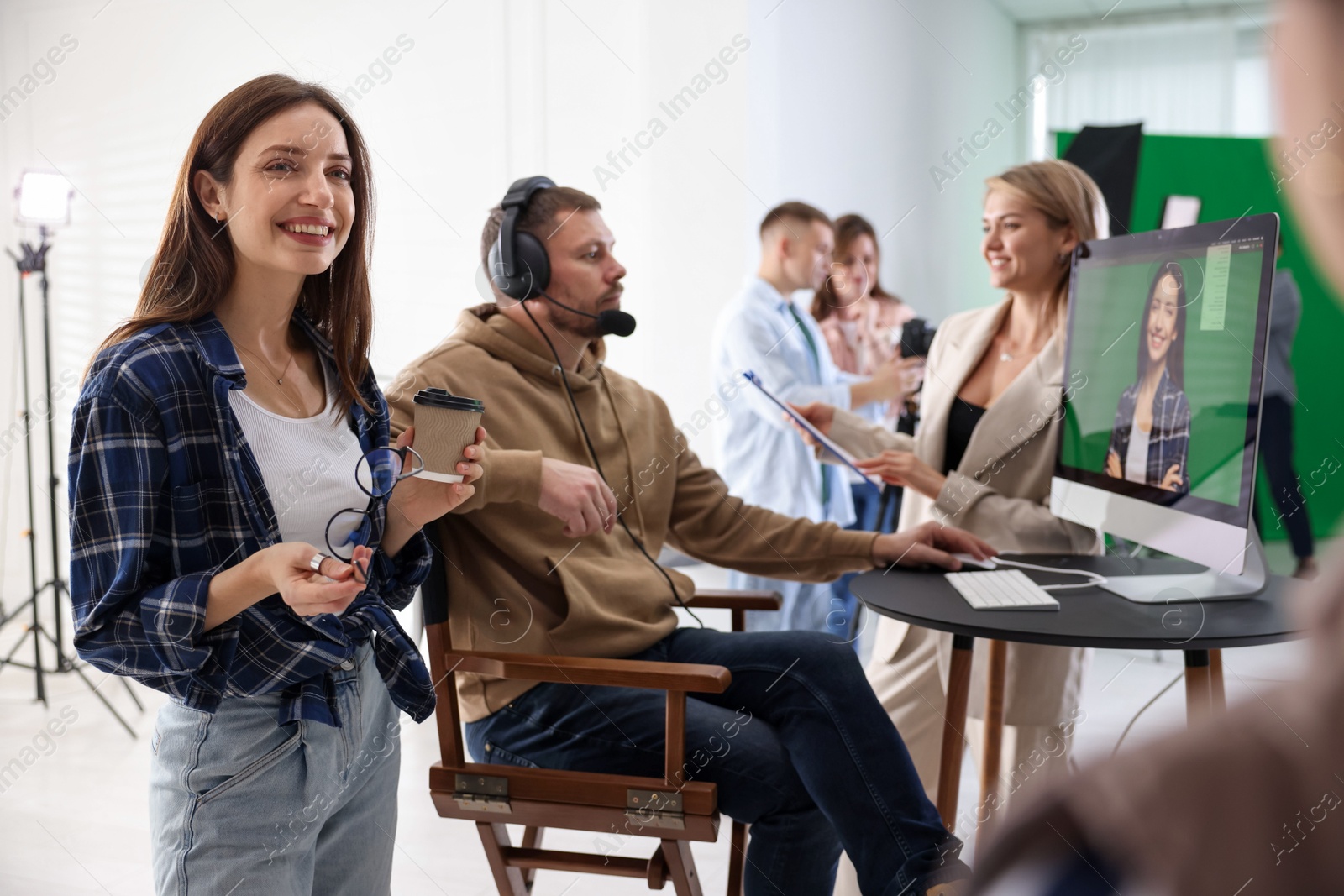 Photo of Group of people working in modern film studio