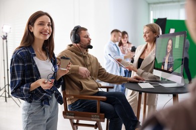 Group of people working in modern film studio