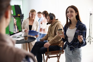 Group of people working in modern film studio