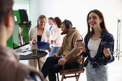 Photo of Group of people working in modern film studio