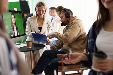 Photo of Group of people working in modern film studio