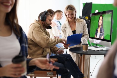 Photo of Group of people working in modern film studio