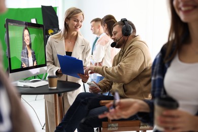 Photo of Group of people working in modern film studio