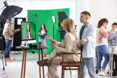 Photo of Group of people working in modern film studio