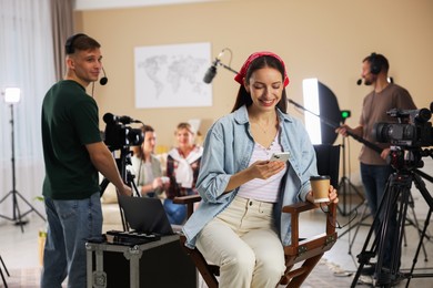 Photo of Group of people working in modern film studio