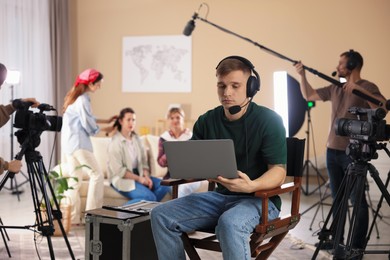 Group of people working in modern film studio