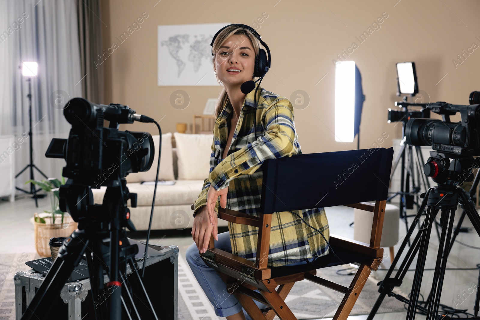 Photo of Happy woman with headphones working in film studio