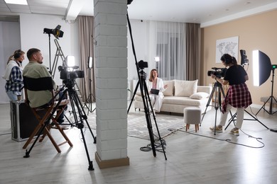 Photo of Group of people working in modern film studio