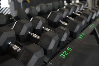 Photo of Different many dumbbells in gym. Sport equipment