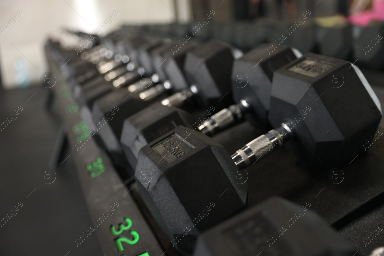 Photo of Different many dumbbells in gym. Sport equipment