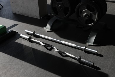 Metal bars and rack with weight plates in gym