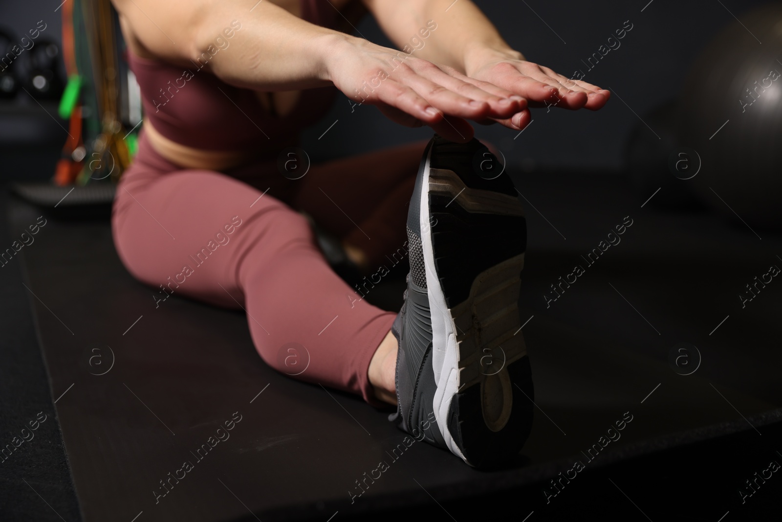 Photo of Woman training on yoga mat in gym, selective focus