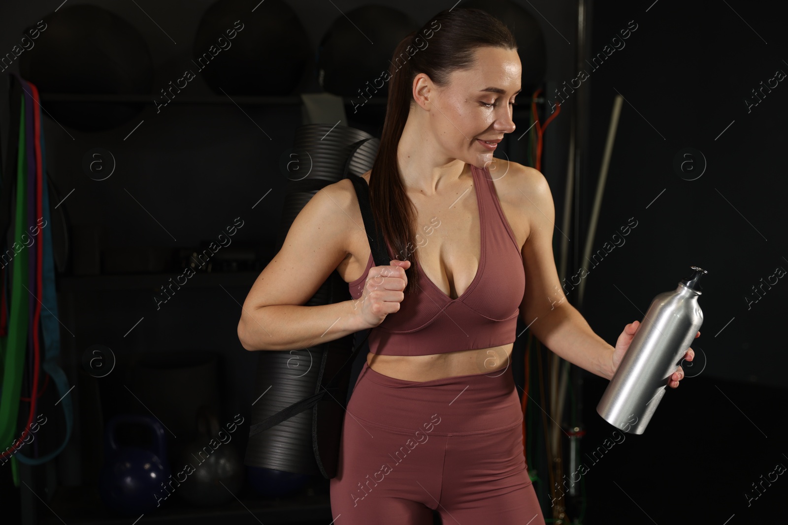 Photo of Smiling woman with thermo bottle in gym. Space for text