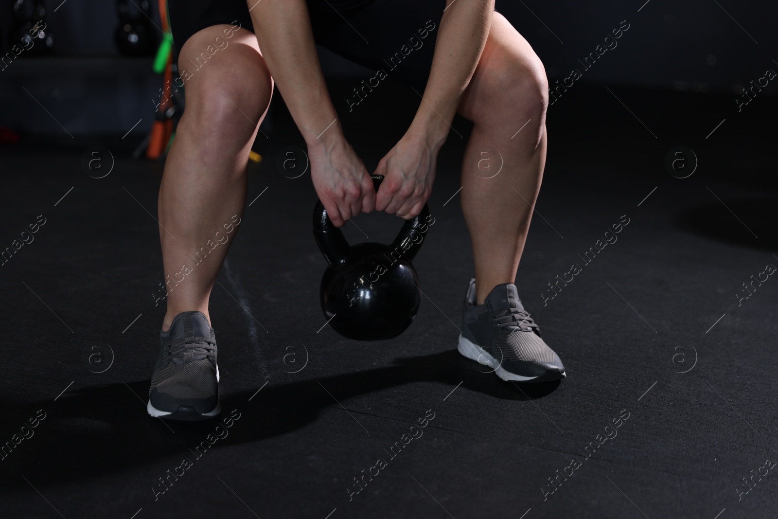 Photo of Woman training with kettlebell in gym, closeup