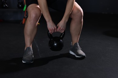 Photo of Woman training with kettlebell in gym, closeup