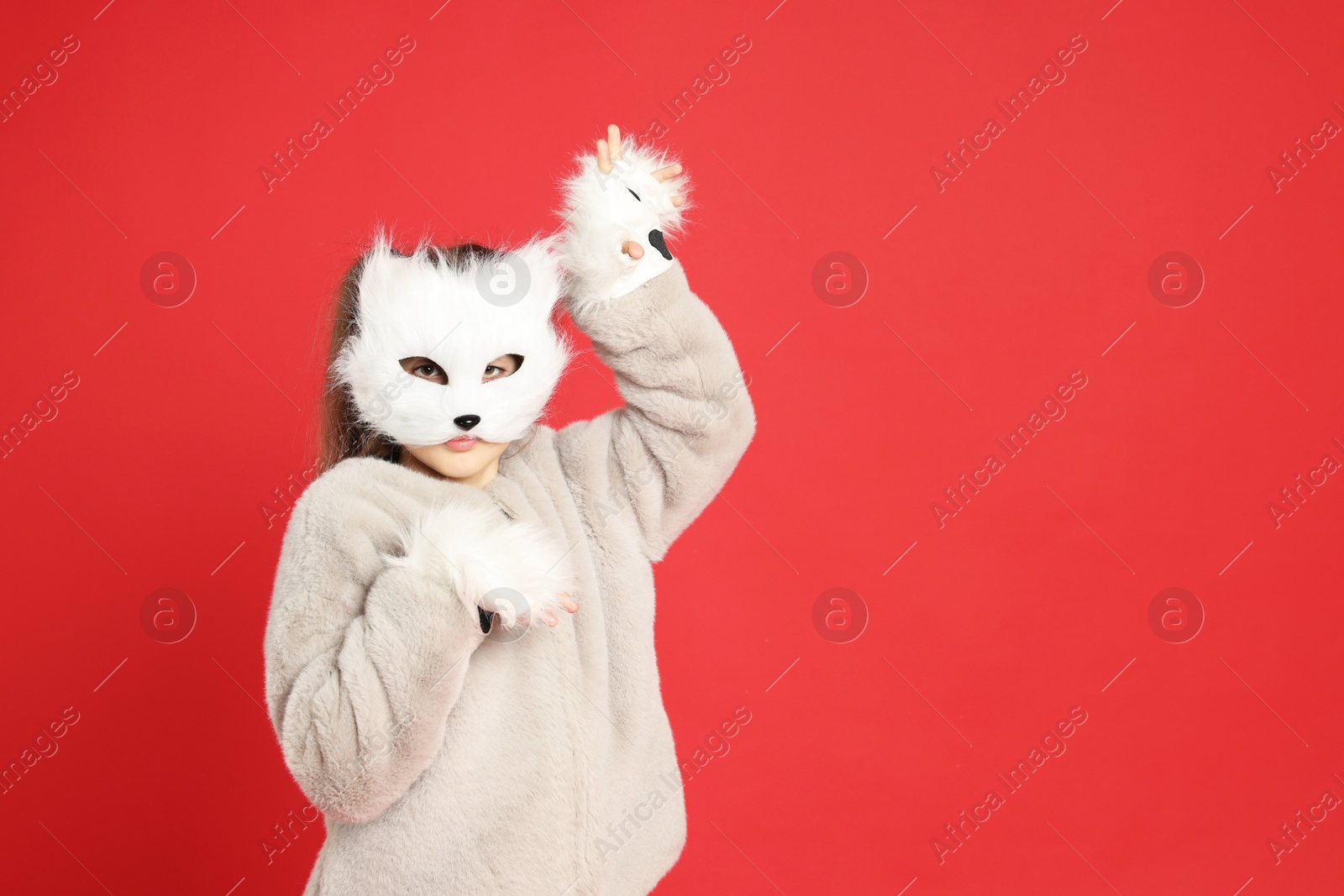 Photo of Quadrobics. Girl wearing cat mask and gloves on red background, space for text