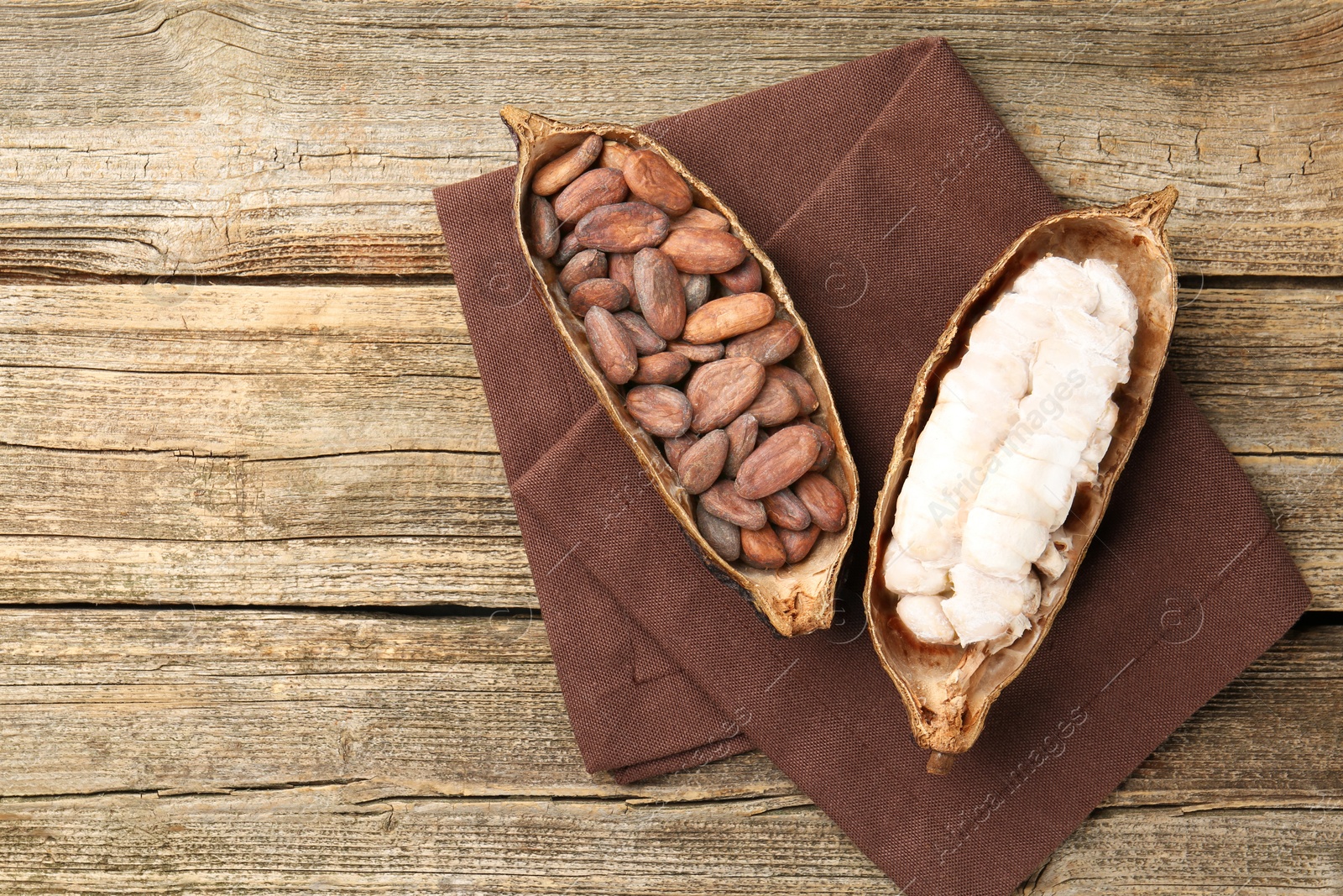 Cocoa pods with beans on wooden table, top view. Space for text Photo of Cocoa pods with beans on wooden table, top view. Space for text