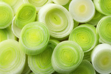 Photo of Pieces of fresh chopped leeks as background, closeup