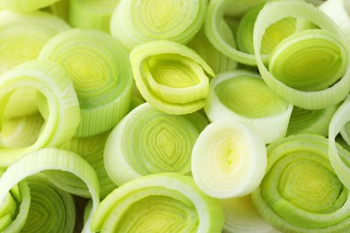 Photo of Pieces of fresh chopped leeks as background, closeup