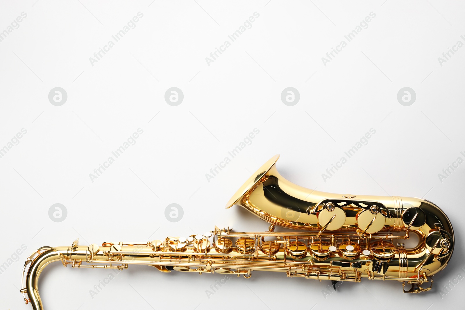 Photo of Jazz. One saxophone on light grey background, top view. Space for text