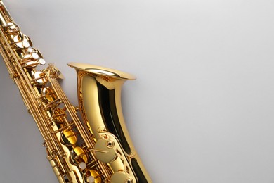 Photo of Jazz. One saxophone on light grey background, top view. Space for text