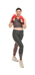 Photo of Plus size woman in gym clothes and boxing gloves on white background