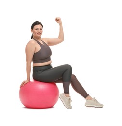 Photo of Plus size woman in gym clothes with fitness ball on white background