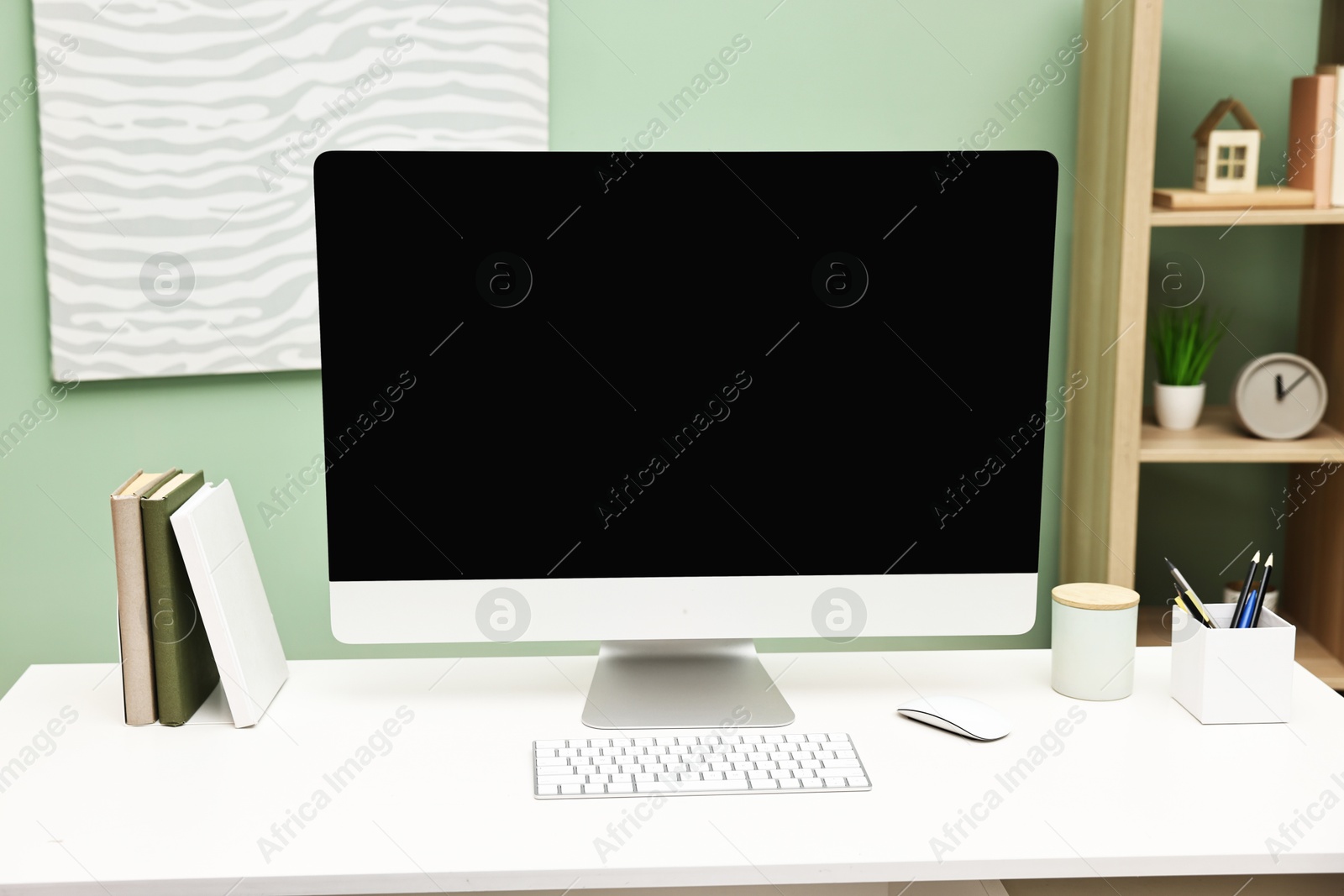 Photo of Comfortable workplace with modern computer and stationery on white table indoors