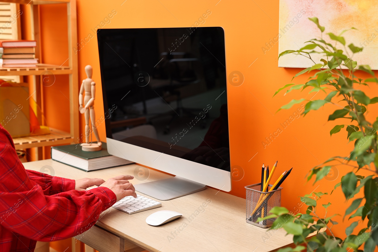 Photo of Woman working on computer at desk indoors, closeup