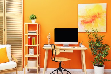 Photo of Comfortable workplace with modern computer and stationery on wooden table indoors