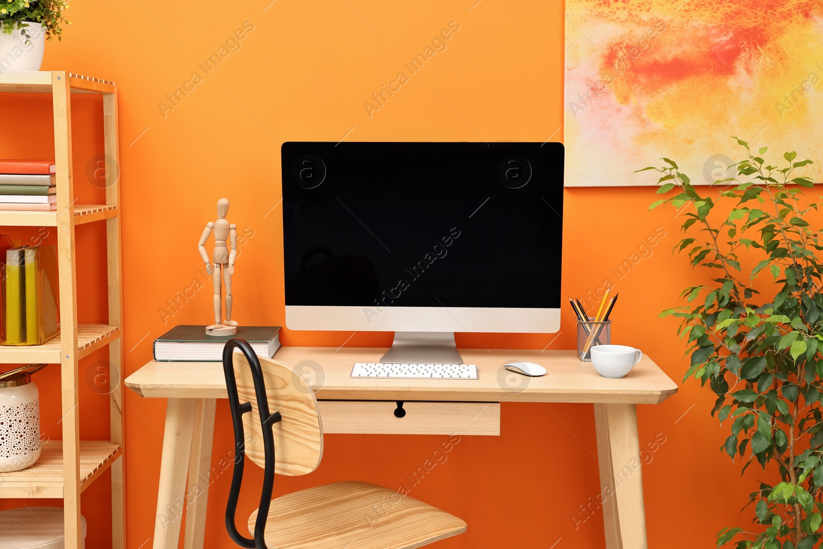 Photo of Comfortable workplace with modern computer and stationery on wooden table indoors