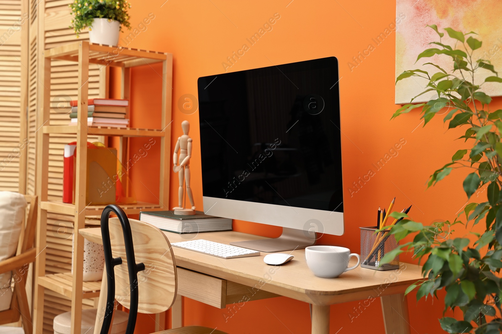 Photo of Comfortable workplace with modern computer and stationery on wooden table indoors