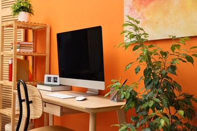 Photo of Comfortable workplace with modern computer on wooden table indoors