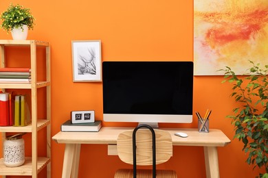 Photo of Comfortable workplace with modern computer on wooden table indoors