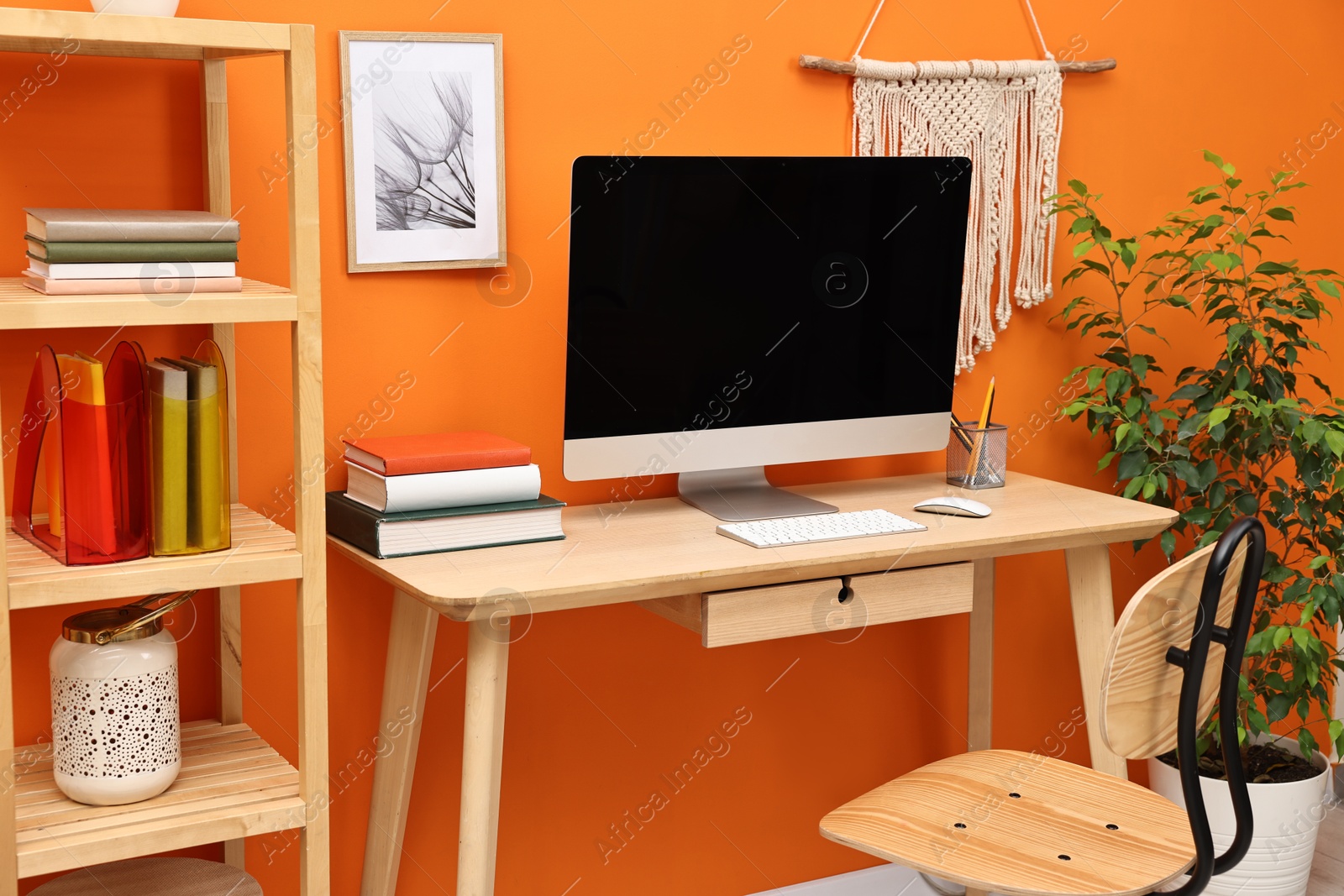 Photo of Comfortable workplace with modern computer on wooden table indoors