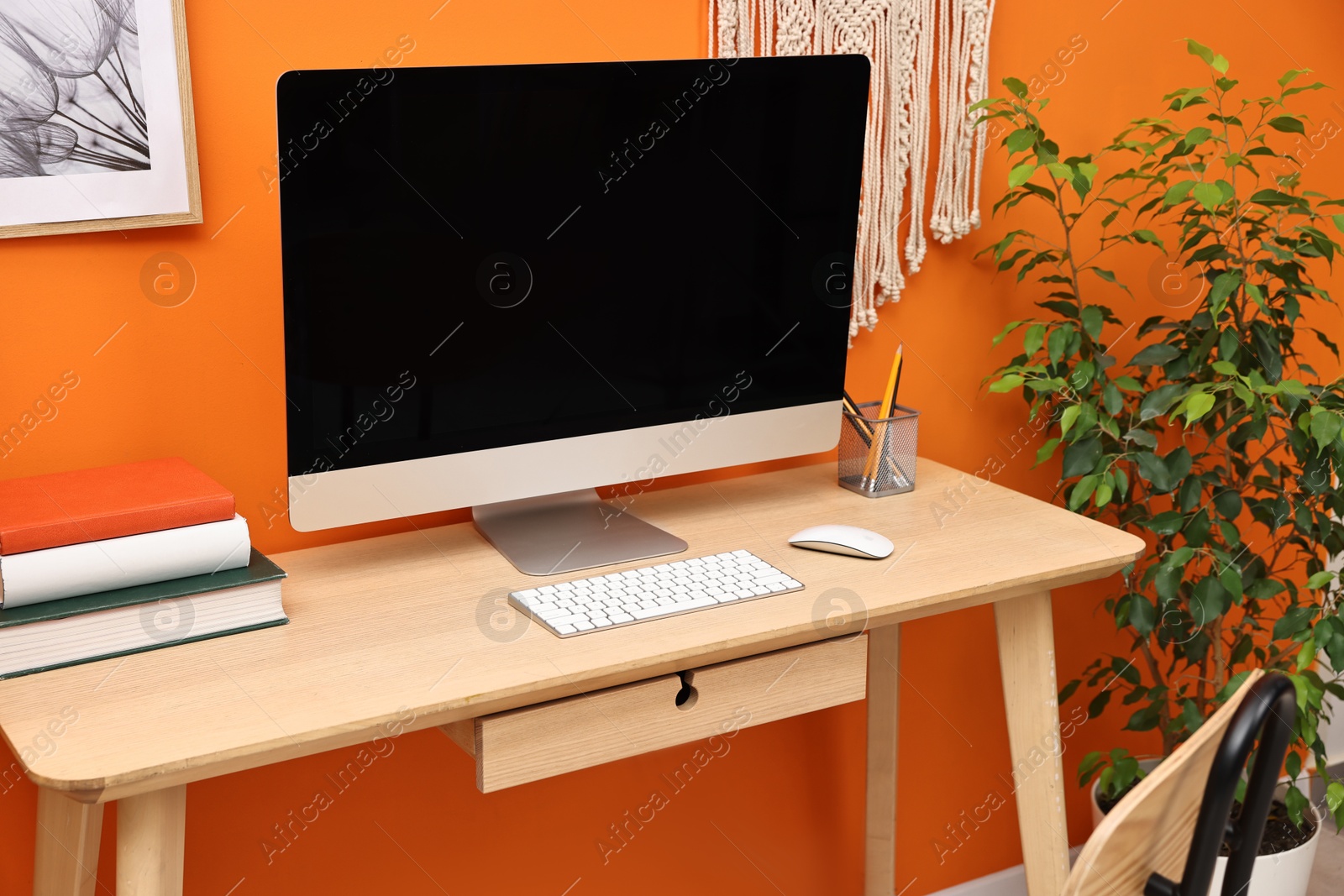 Photo of Comfortable workplace with modern computer on wooden table indoors