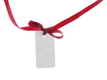 Photo of Blank tag with red ribbon bow isolated on white