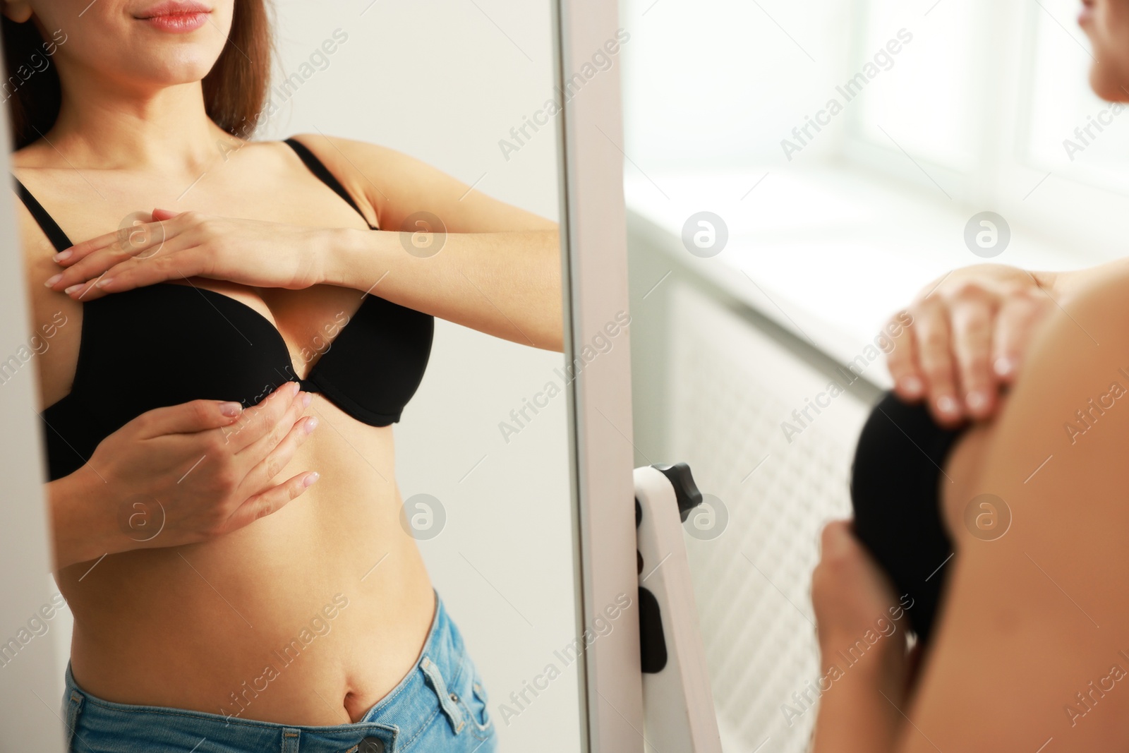 Photo of Woman wearing beautiful bra near mirror indoors, closeup