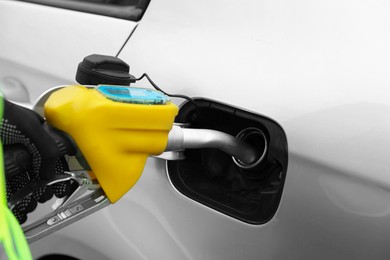 Photo of Man refueling his car at gas station, closeup