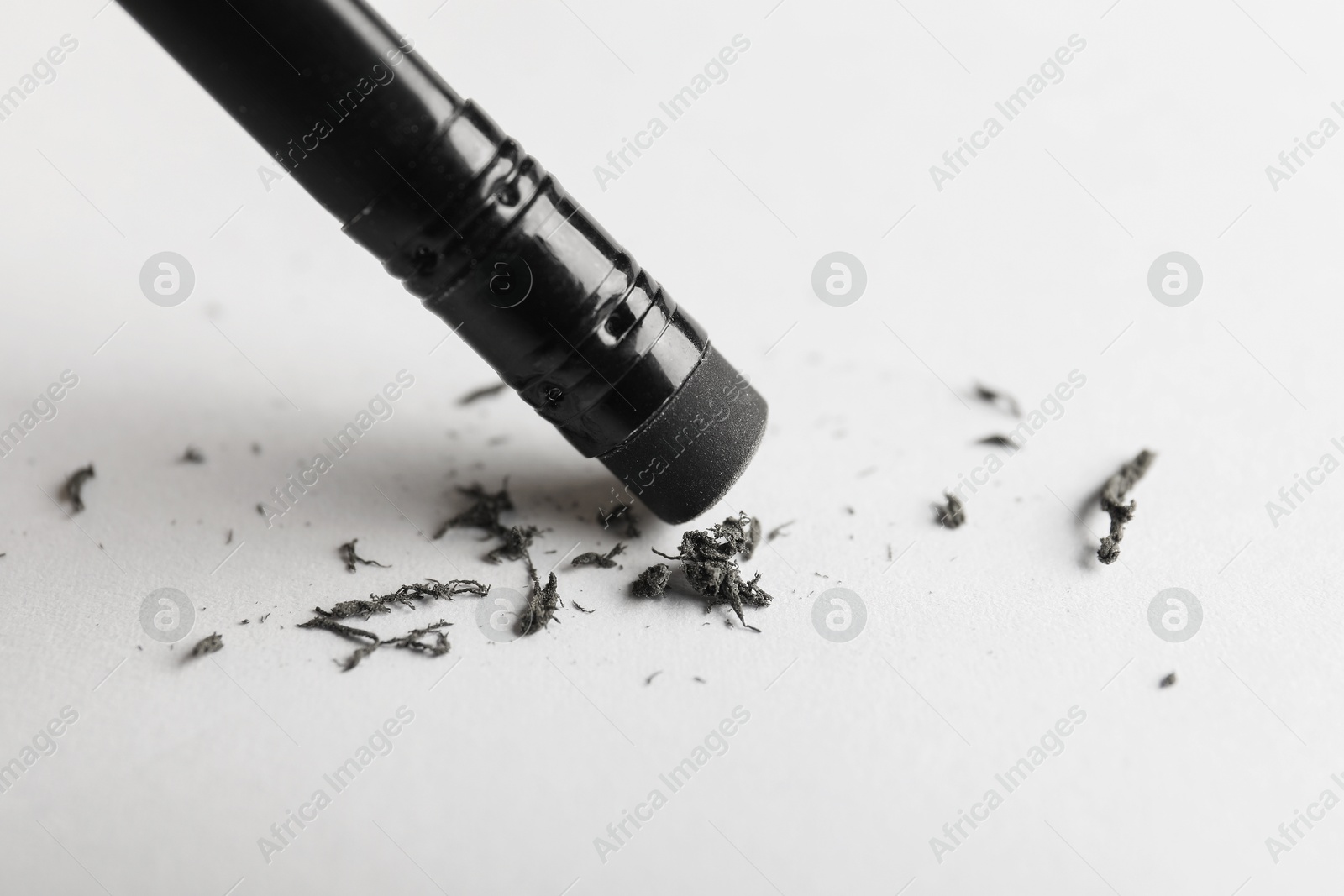Using pencil with eraser on white sheet of paper, closeup Photo of Using pencil with eraser on white sheet of paper, closeup