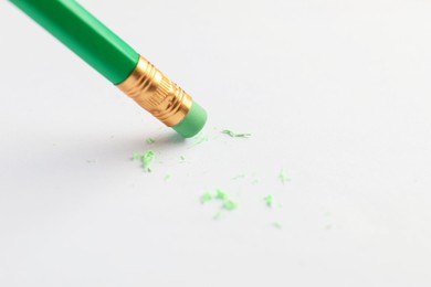 Photo of Using pencil with eraser on white sheet of paper, closeup