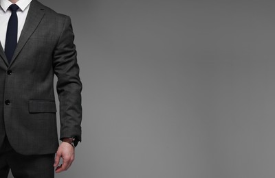 Photo of Man in classic suit on grey background, closeup