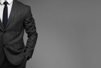 Photo of Man in classic suit on grey background, closeup