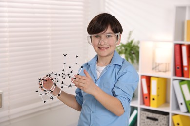 Smiling boy with DNA structure model indoors